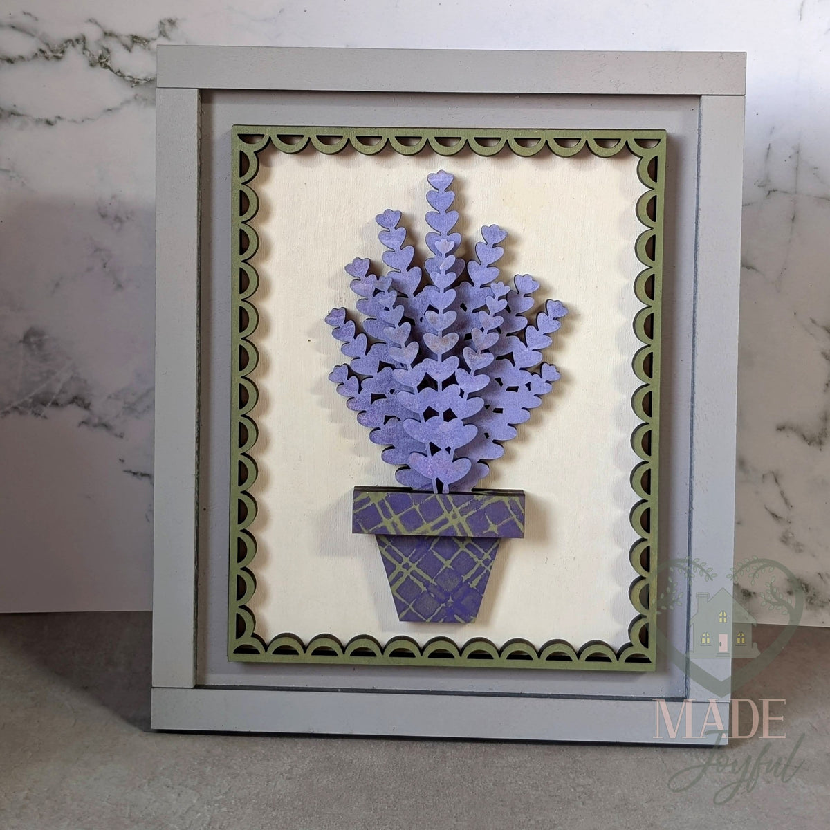 Potted lavender 3D wood insert with layered purple heart-shaped blooms in a plaid pot on cream with a sage scalloped border, in a gray farmhouse frame, hand-painted in Brentwood, TN.