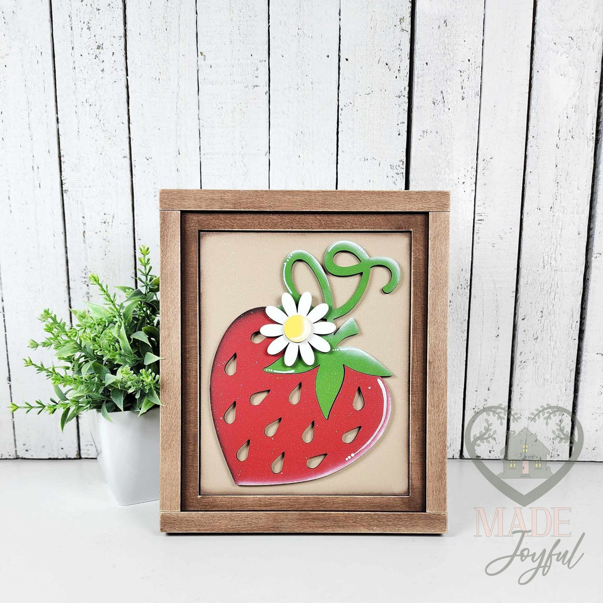 Hand-painted 3D wood strawberry insert with a white daisy and curly green stem on a tan background in a stained farmhouse frame, handmade in Brentwood, TN.