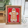 Hand-painted 3D wood gingerbread man with pink hearts and a white bow tie on a red polka-dot background in a stained 7x8 farmhouse frame.