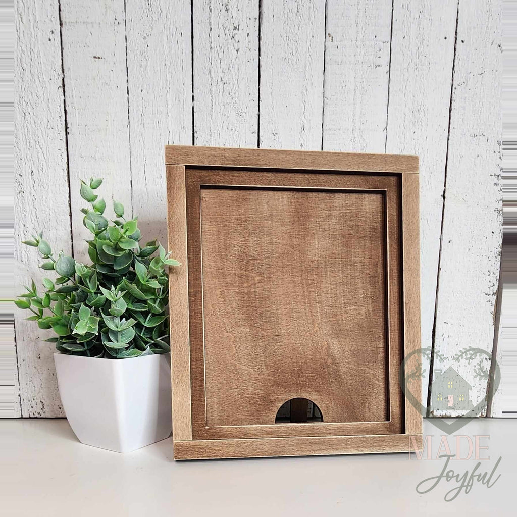 Empty 7x8 stained wood interchangeable farmhouse frame showing the slot that holds each 5x6.25 insert, available with the Starter Kit.