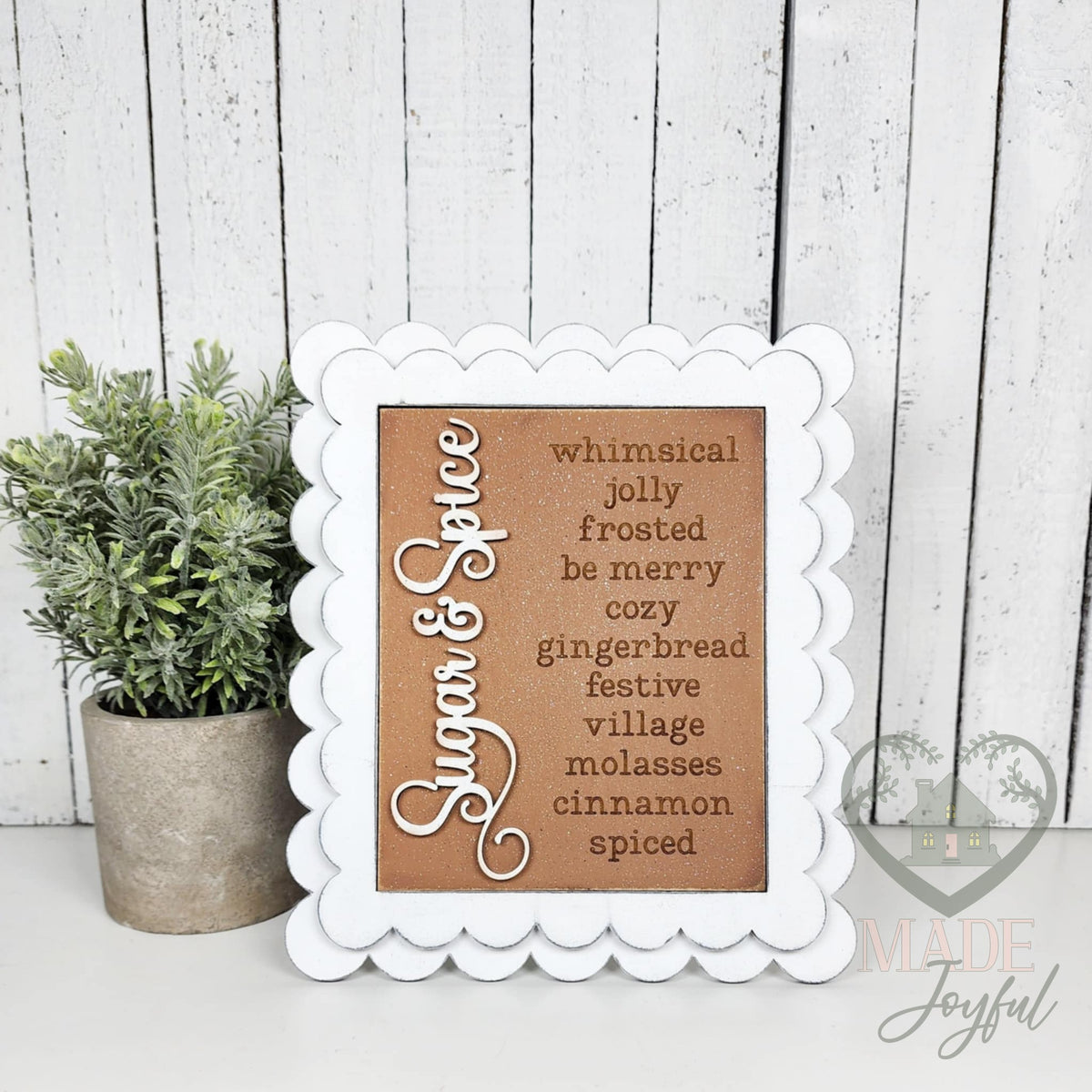 Sugar & Spice word-list insert with whimsical, jolly, frosted, be merry, cozy, gingerbread, festive, village, molasses, cinnamon, and spiced in a white scalloped frame.