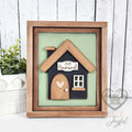 Black 3D wood house insert with a wood roof, arched door with heart, and a 2009 Howard family name plaque on a sage green background in a stained farmhouse frame.