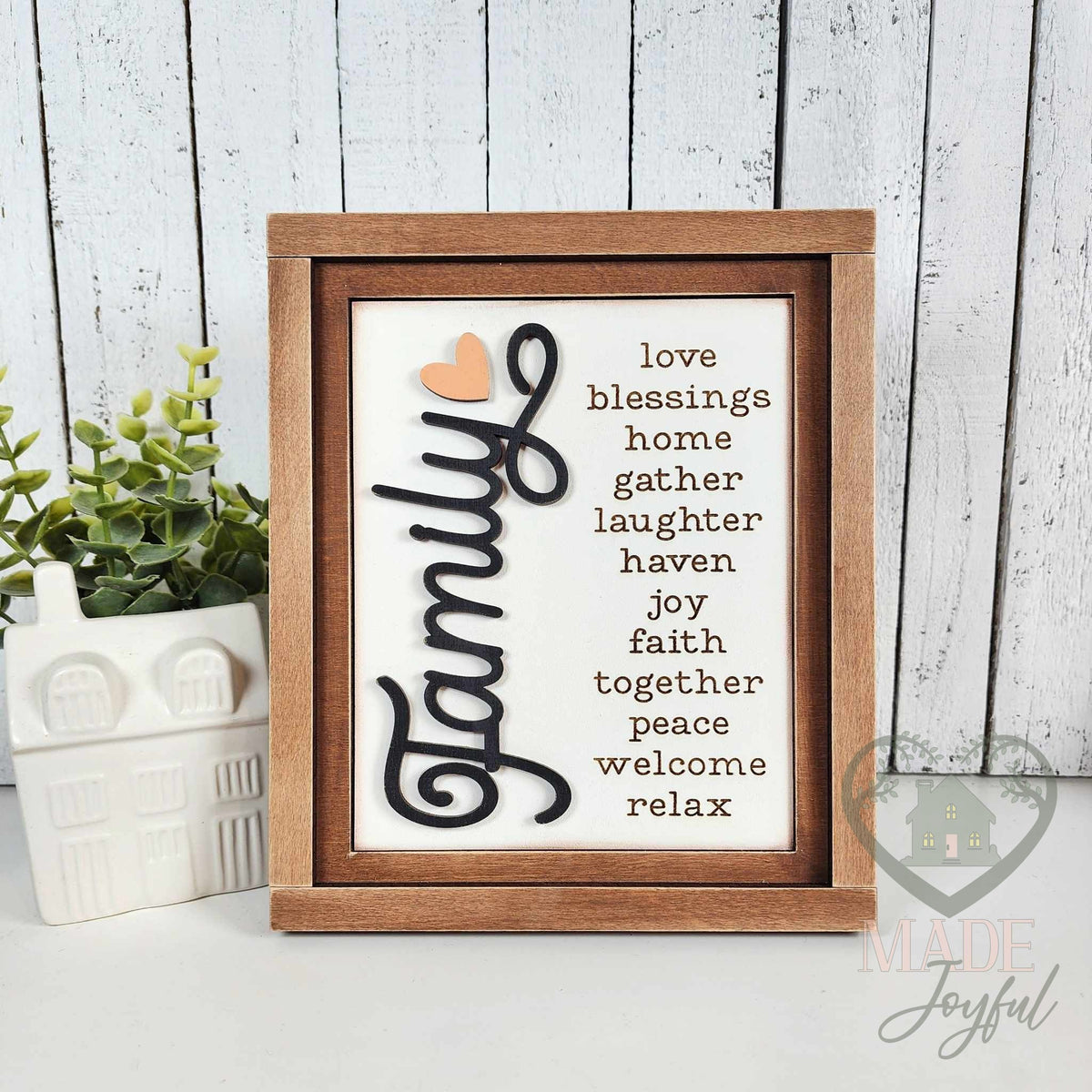 Family word-list insert with love, blessings, home, gather, laughter, haven, joy, faith, together, peace, welcome, and relax in black script on white, in a stained farmhouse frame.