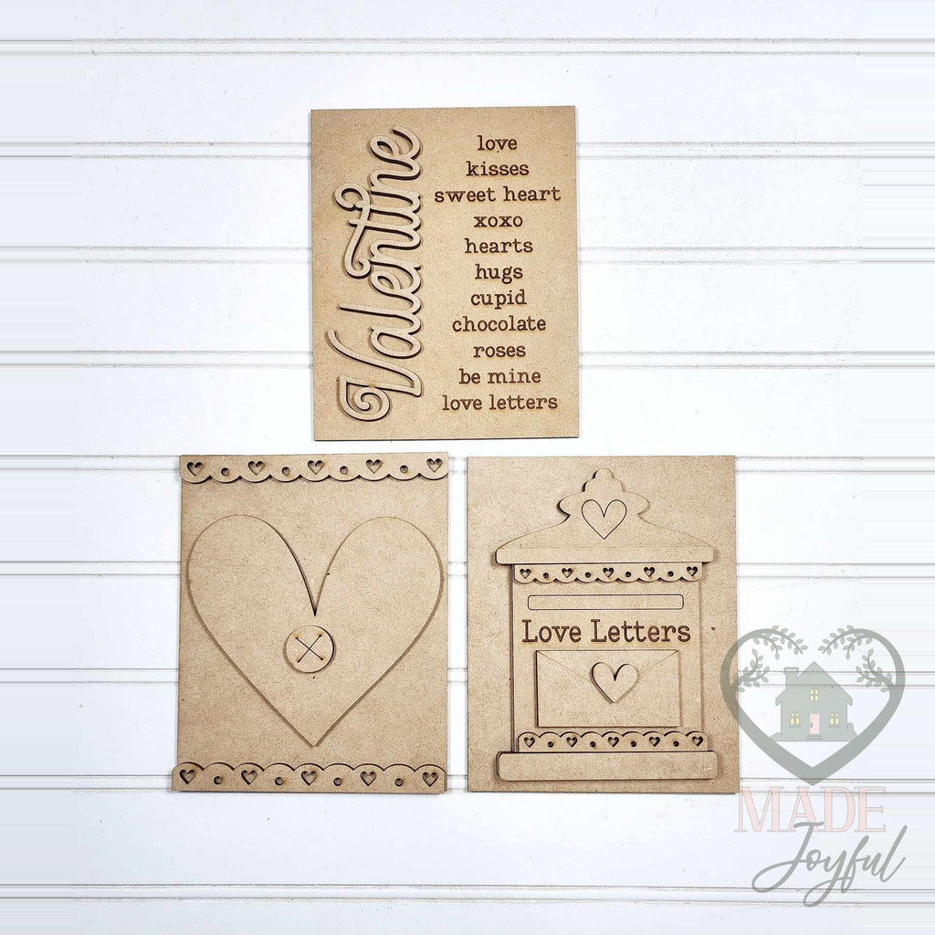 Unfinished laser-cut wood Valentine trio DIY kit with Valentine word list, heart, and Love Letters mailbox inserts, ready to paint at a DIY party in Williamson County, TN.