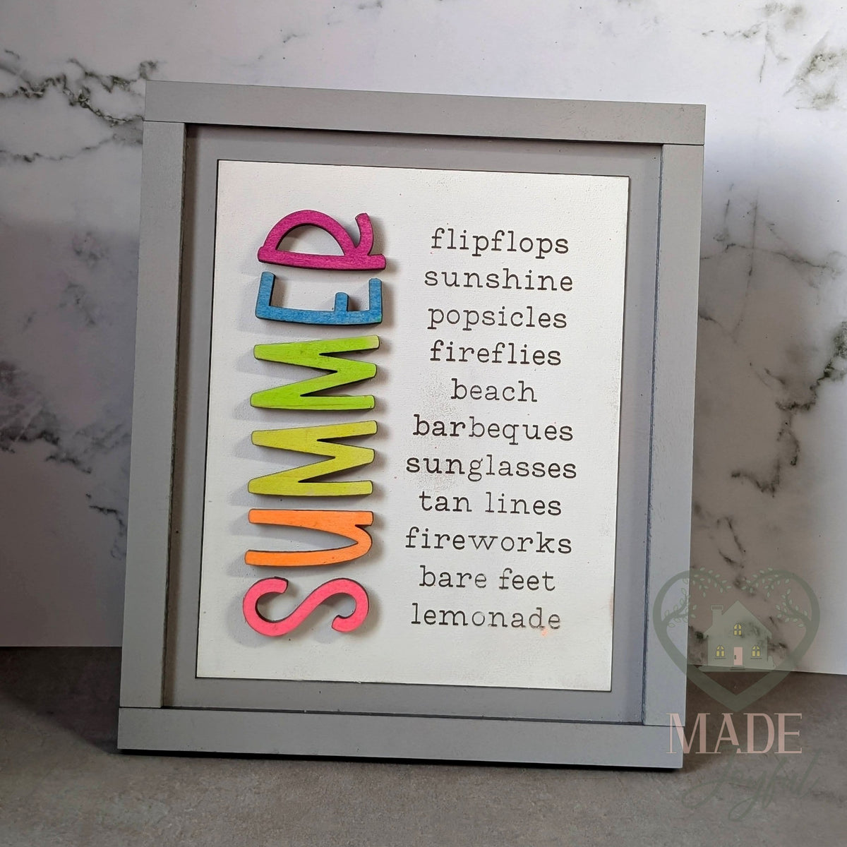 SUMMER word-list 3D wood insert with rainbow ombre letters and the words flip flops, sunshine, popsicles, fireflies, beach, barbeques, sunglasses, tan lines, fireworks, bare feet, and lemonade, in a gray farmhouse frame, hand-painted in Brentwood, TN.