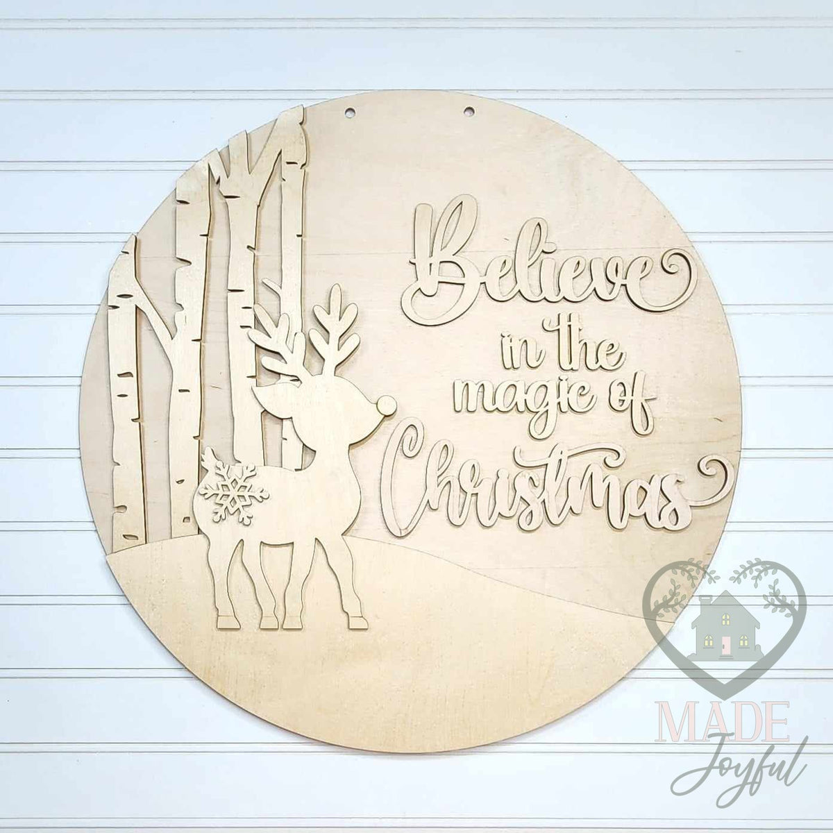 Unfinished laser-cut wood Believe in the Magic of Christmas reindeer door hanger kit, ready to paint at a DIY party in Williamson County, TN.