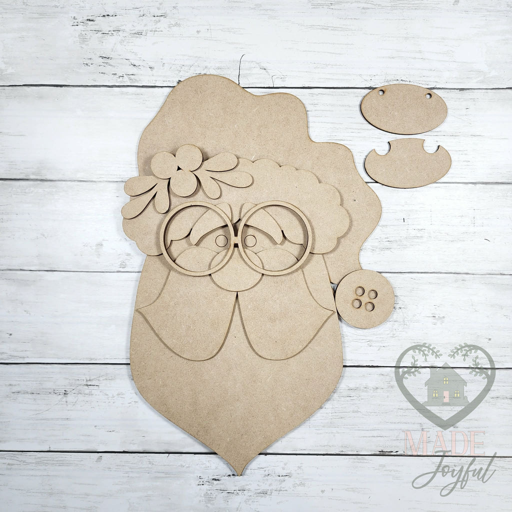 Unfinished laser-cut wood Santa face door hanger kit with glasses, beard, and hat pieces, ready to paint at a DIY party in Williamson County, TN.