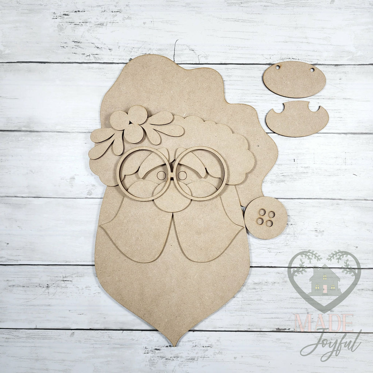Unfinished laser-cut wood Santa face door hanger kit with glasses, beard, and hat pieces, ready to paint at a DIY party in Williamson County, TN.