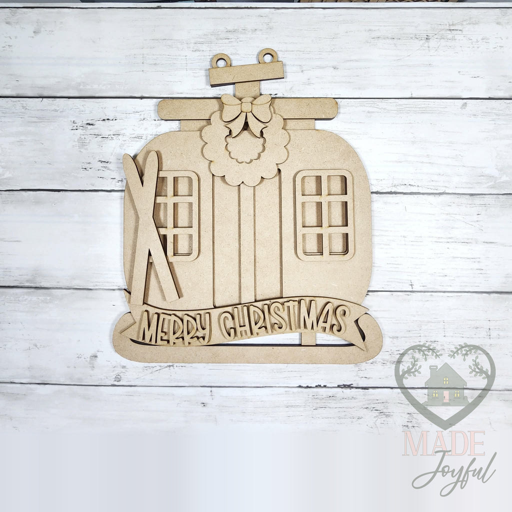 Unfinished laser-cut wood ski gondola Merry Christmas door hanger kit, ready to paint at a DIY party in Williamson County, TN.