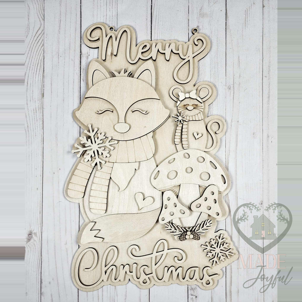 Unfinished laser-cut wood Forest Friends Merry Christmas door hanger kit, ready to paint at a DIY party in Williamson County, TN.