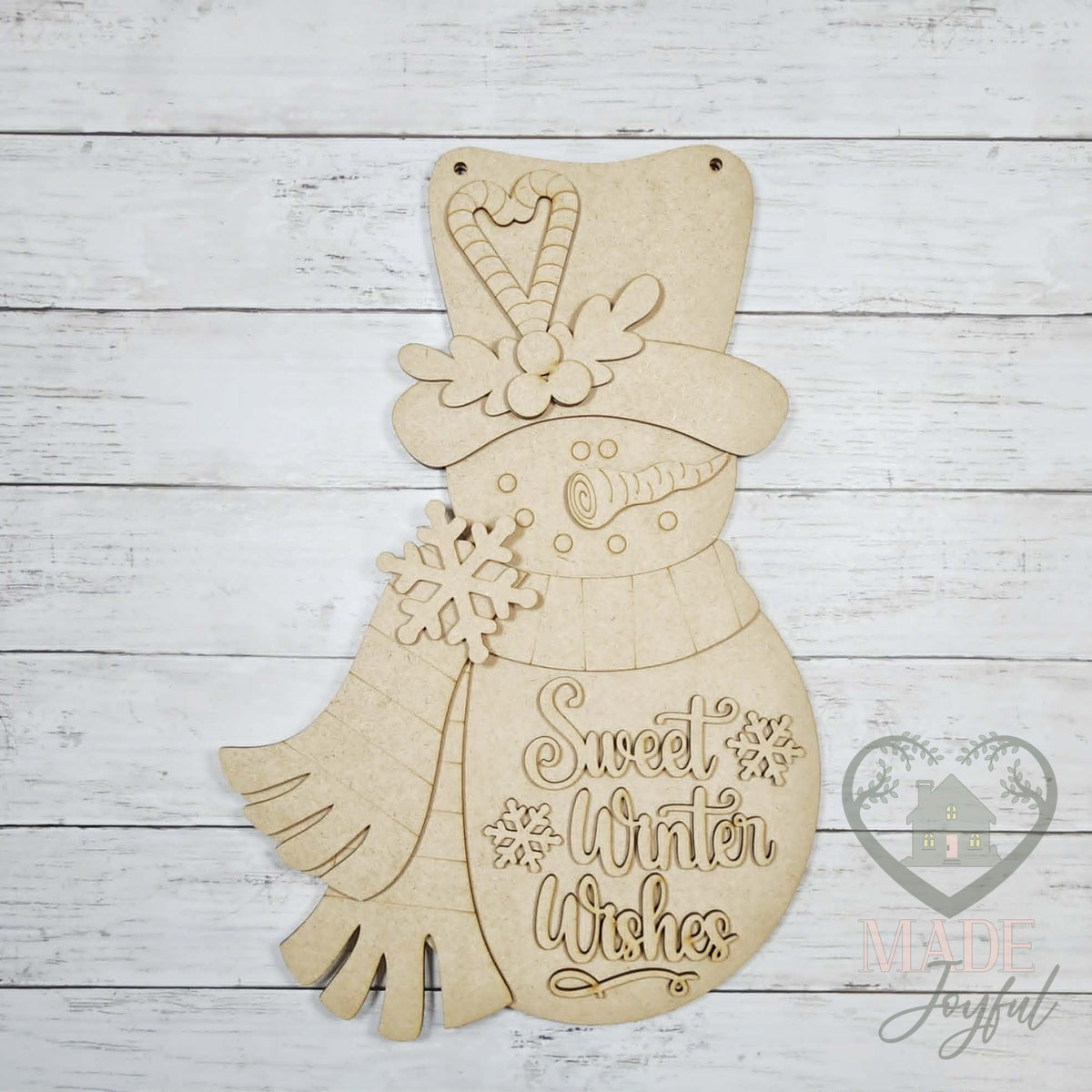Unfinished laser-cut wood Sweet Winter Wishes snowman door hanger kit, ready to paint at a DIY party in Williamson County, TN.