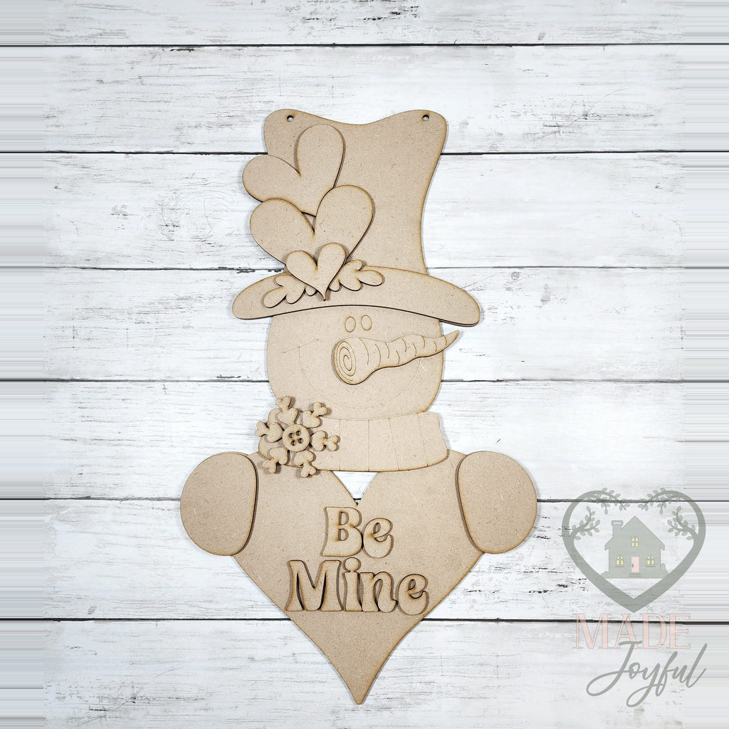 Unfinished laser-cut wood Be Mine Valentine snowman door hanger kit, ready to paint at a DIY party in Williamson County, TN.
