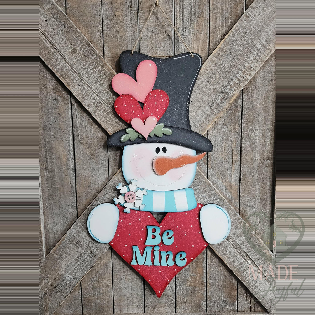 Be Mine Valentine snowman 3D wood door hanger with a heart-topped black hat, aqua scarf, and a red polka-dot heart, hand-painted in Brentwood, TN.