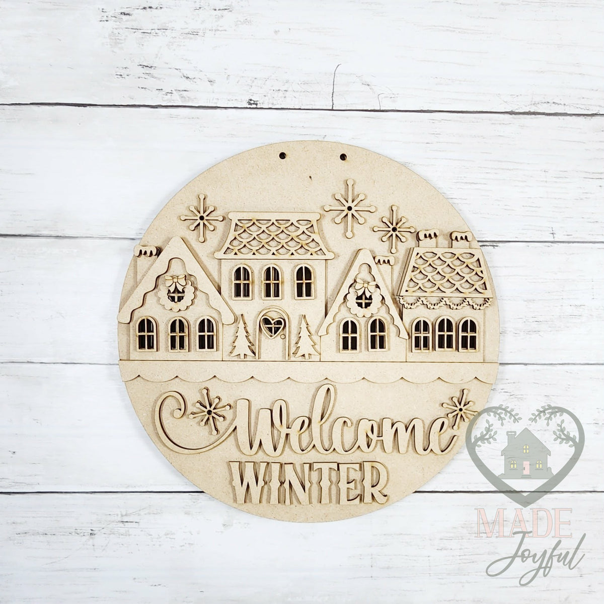 Unfinished laser-cut wood Welcome Winter Village door hanger kit, ready to paint at a DIY party in Williamson County, TN.
