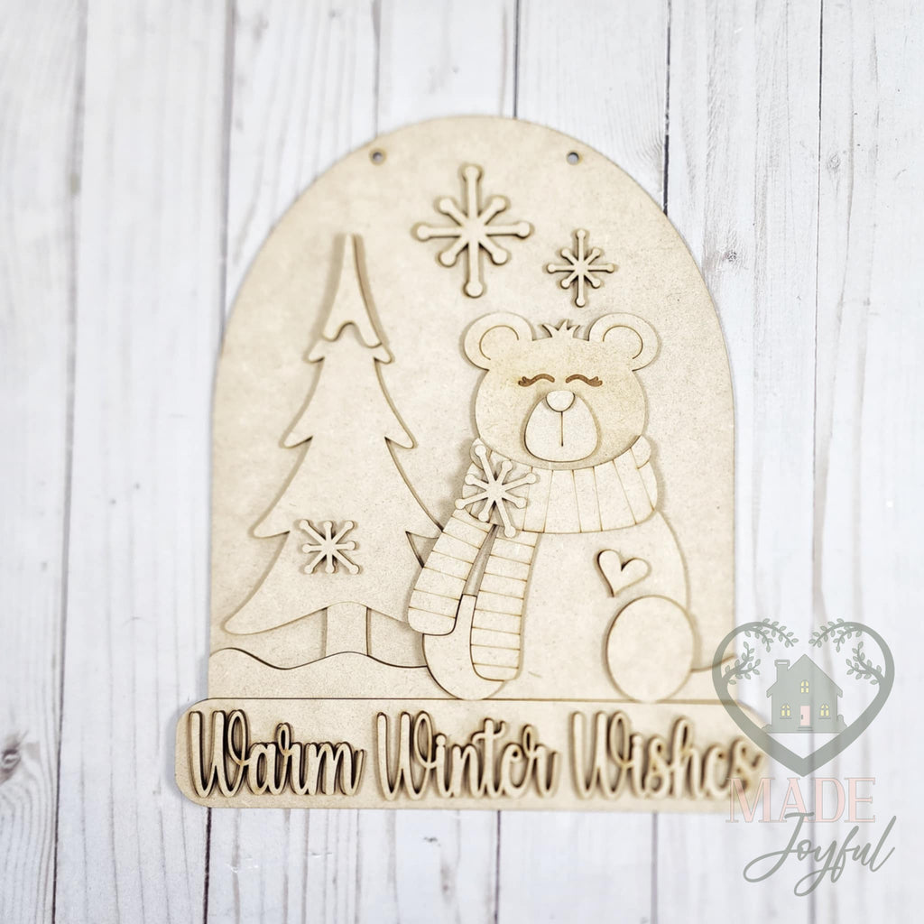 Unfinished laser-cut wood Warm Winter Wishes polar bear door hanger kit, ready to paint at a DIY party in Williamson County, TN.
