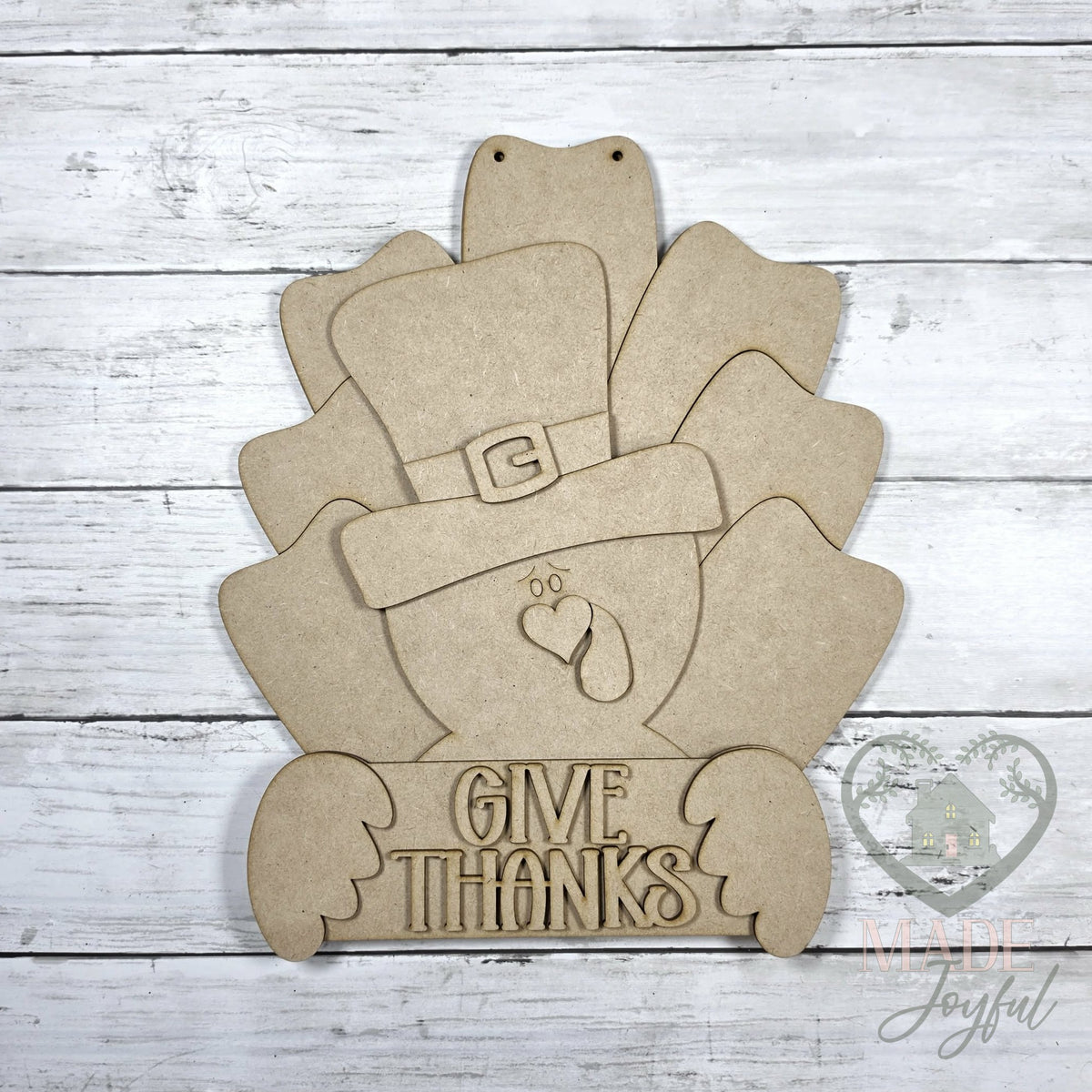 Unfinished laser-cut wood Give Thanks pilgrim turkey door hanger kit, ready to paint at a DIY party in Williamson County, TN.