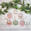 Six round wood Christmas ornaments reading Cheer, Merry, Jolly, Noel, Joy and Believe in pink, sage and cream with bead hangers, hand-painted in Brentwood, TN.