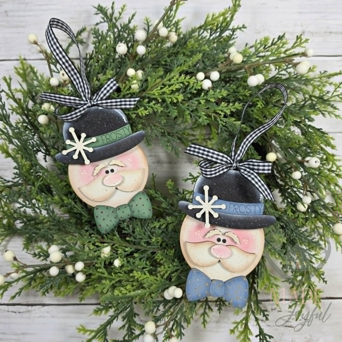 Two Sir Winston snowman ornaments in black bowler hats with snowflakes and bow ties, hung with gingham ribbon, hand-painted in Brentwood, TN.