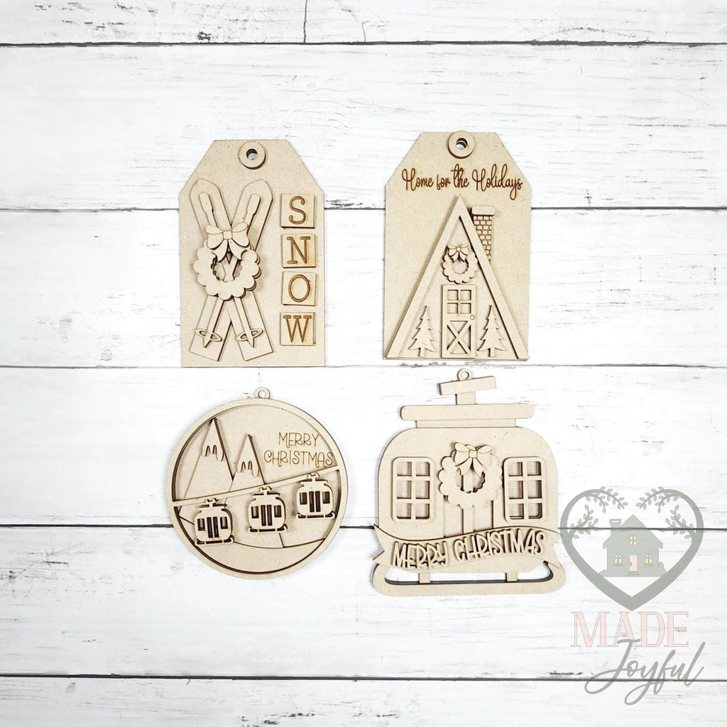 Unfinished laser-cut wood ski lodge ornament kit with four ornaments, ready to paint at a DIY party in Williamson County, TN.
