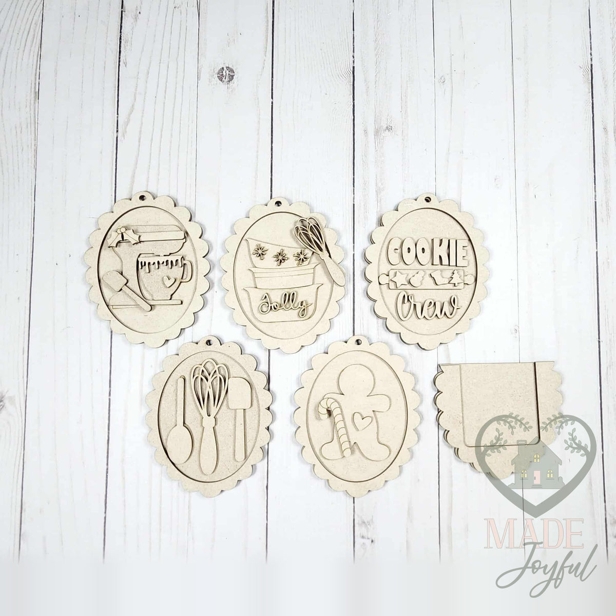 Unfinished laser-cut wood Christmas baking ornament kit with five ornaments and gift card backer, ready to paint at a DIY party in Williamson County, TN.