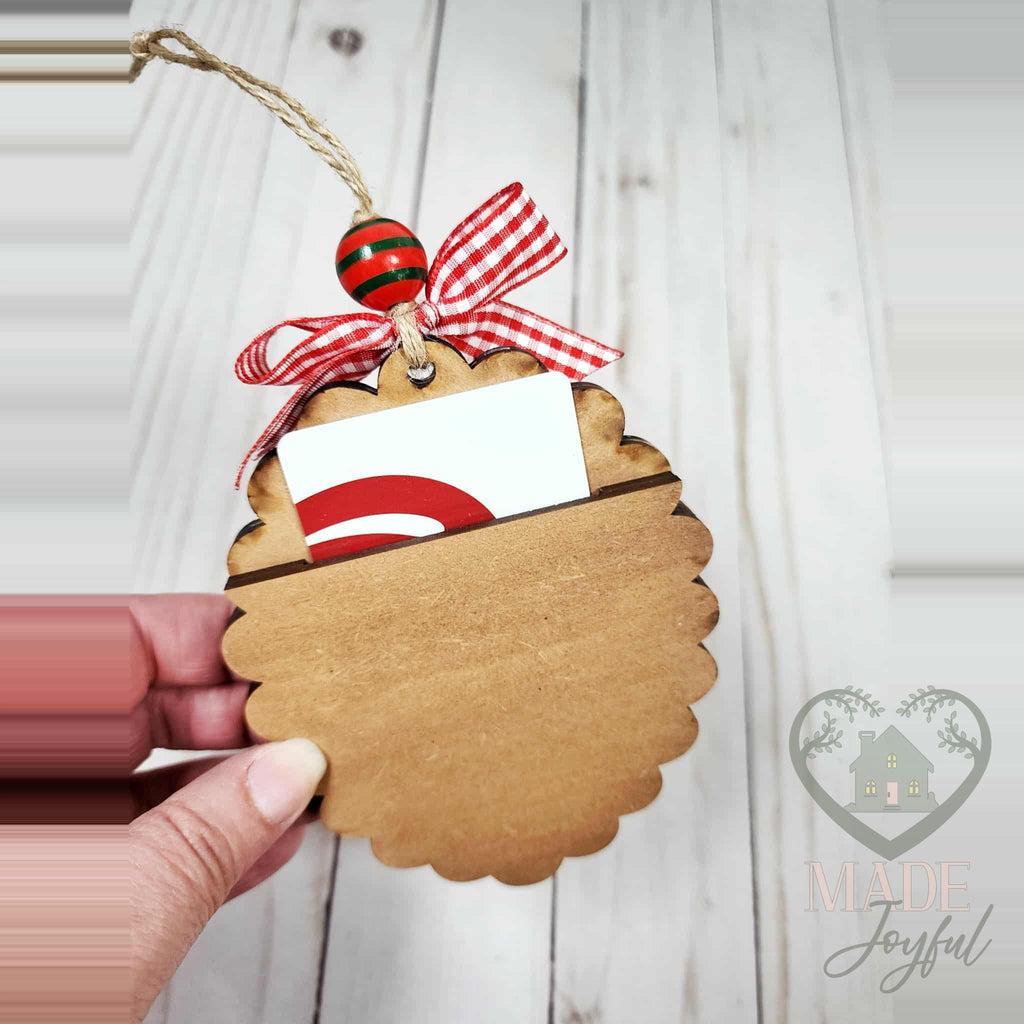 Scalloped baking ornament with a gift card tucked into its back pocket