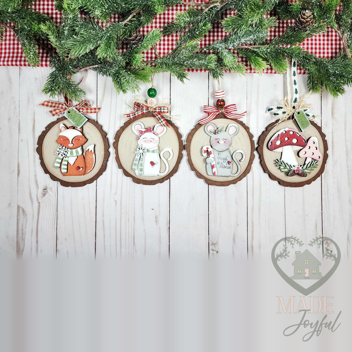 Four forest friends ornaments on wood-slice rounds with a fox, white mouse, gray mouse and red mushroom, hung with gingham bows, hand-painted in Brentwood, TN.