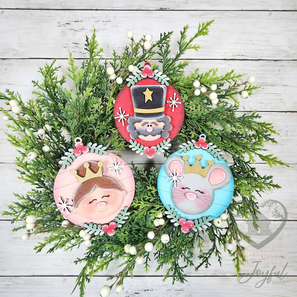 Nutcracker ballet ornament set with the Nutcracker, Clara and the Mouse King on round frames with pink roses, hand-painted in Brentwood, TN.
