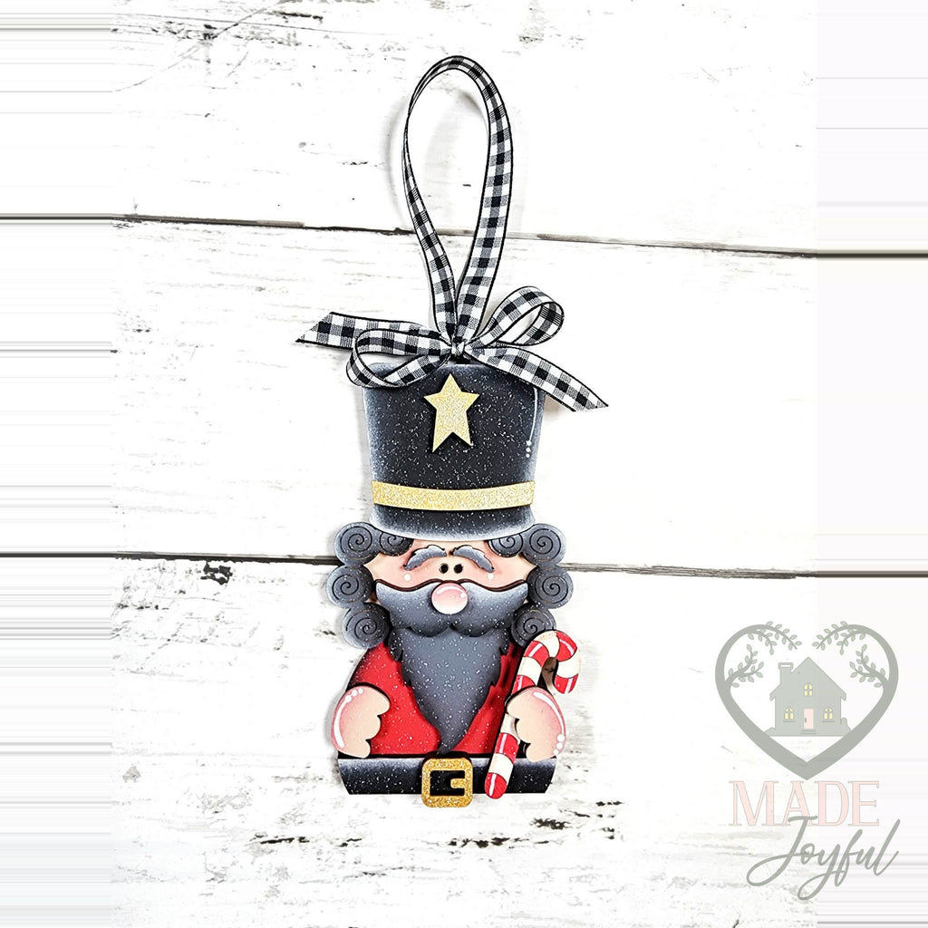 Standing nutcracker ornament with a tall black hat, gray curls and a candy cane, hand-painted in Brentwood, TN.