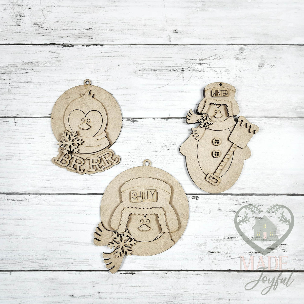 Unfinished laser-cut wood penguin ornament kit with three ornaments, ready to paint at a DIY party in Williamson County, TN.