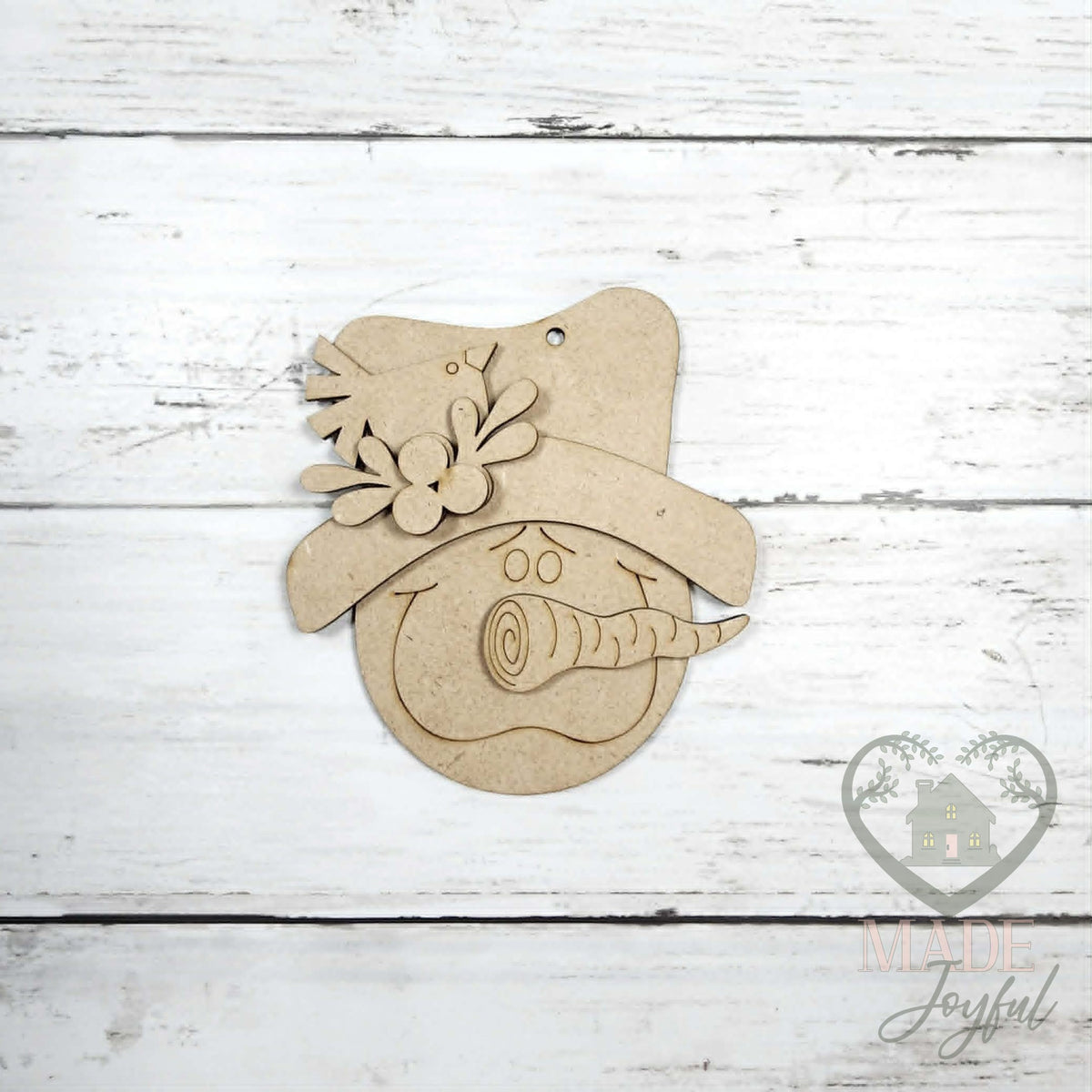 Unfinished laser-cut wood snowman face ornament kit, ready to paint at a DIY party in Williamson County, TN.