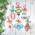 Six vintage-style wood ornaments in pink, aqua and red with Joy, Peace and Noel lettering and gingham ribbon, hand-painted in Brentwood, TN.