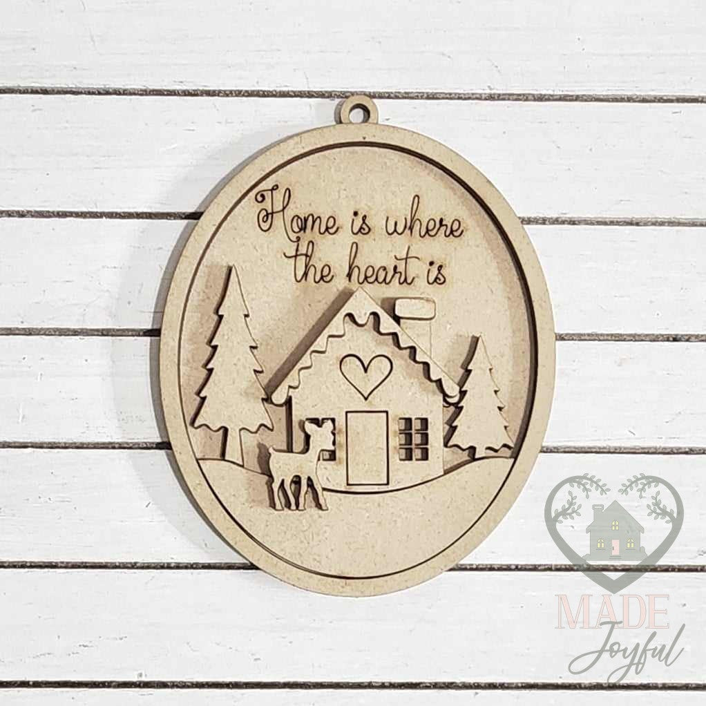 Unfinished laser-cut wood winter cabin ornament kit, ready to paint at a DIY party in Williamson County, TN.
