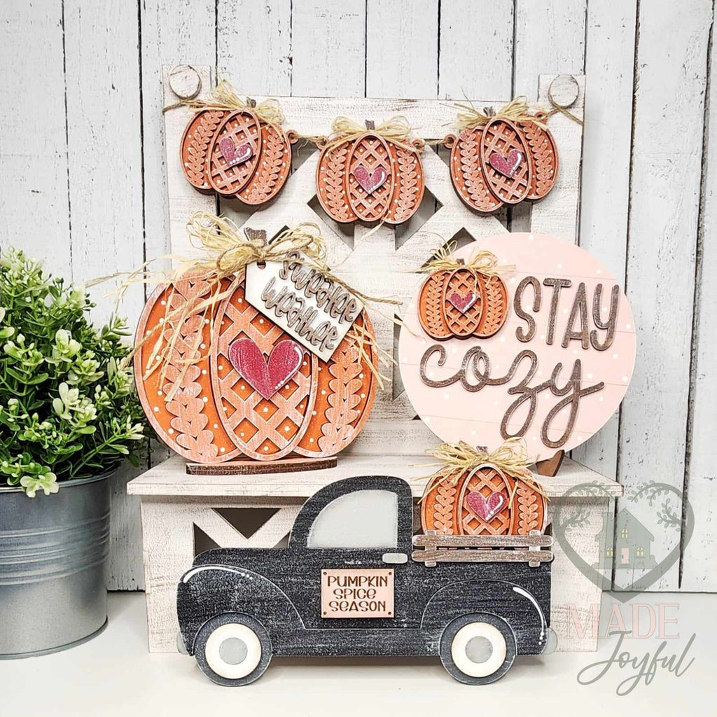 Sweater Weather tiered tray decor set with knit pumpkins, Stay Cozy round sign, black pumpkin truck, and pumpkin banner, hand-painted in Brentwood, TN.