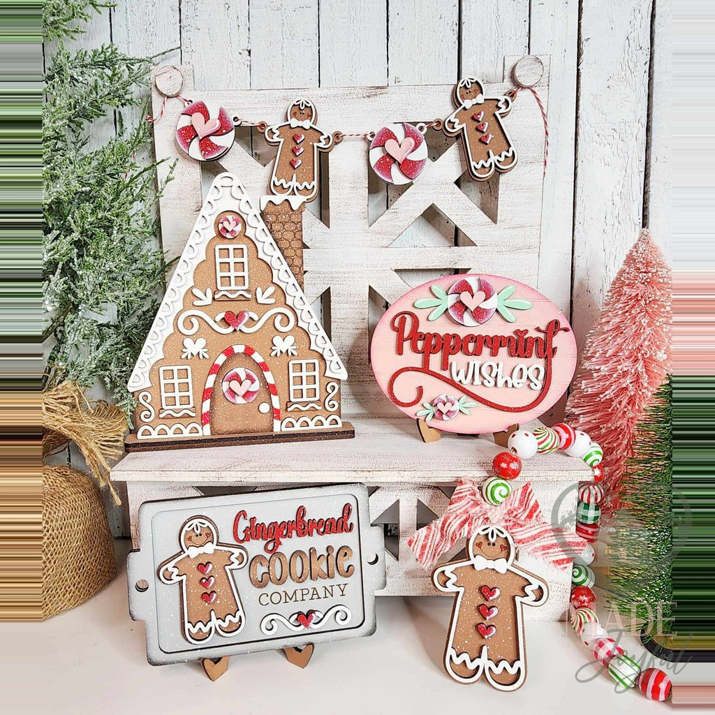 Gingerbread tiered tray decor set with frosted house, Peppermint Wishes sign, Gingerbread Cookie Company sign, and gingerbread banner, hand-painted in Brentwood, TN.