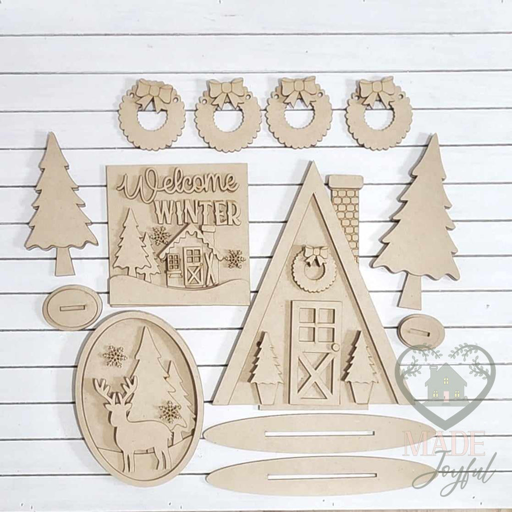 Unfinished laser-cut wood Winter Cabin Tiered Tray Decor Set DIY kit, ready to paint at a DIY party in Williamson County, TN.