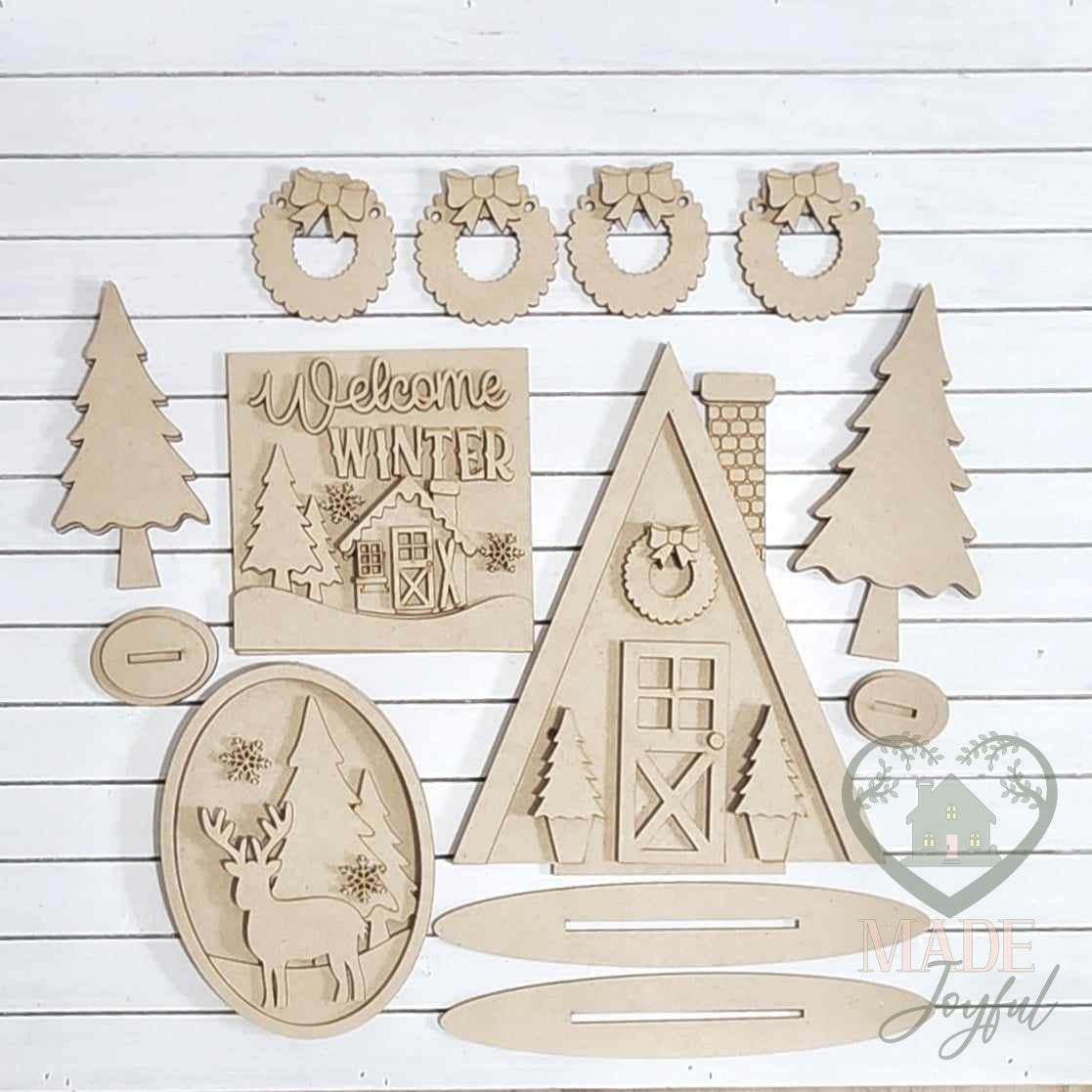 Unfinished laser-cut wood Winter Cabin Tiered Tray Decor Set DIY kit, ready to paint at a DIY party in Williamson County, TN.