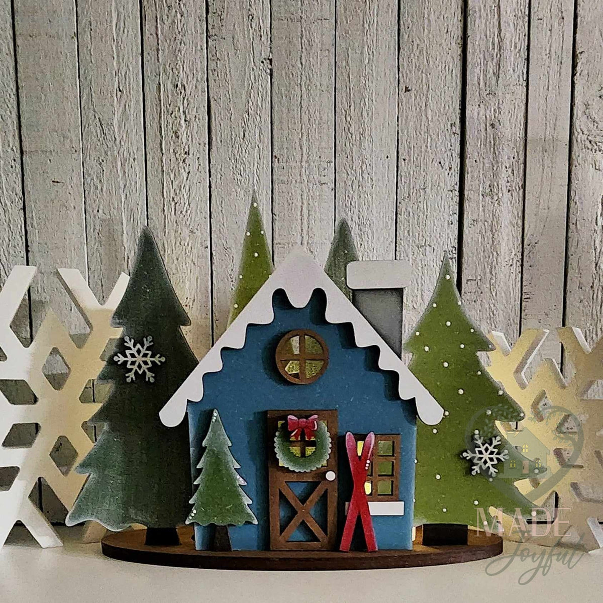 Winter cabin mantel scene in deep blue with snowy trees, hand-painted in Brentwood, TN.