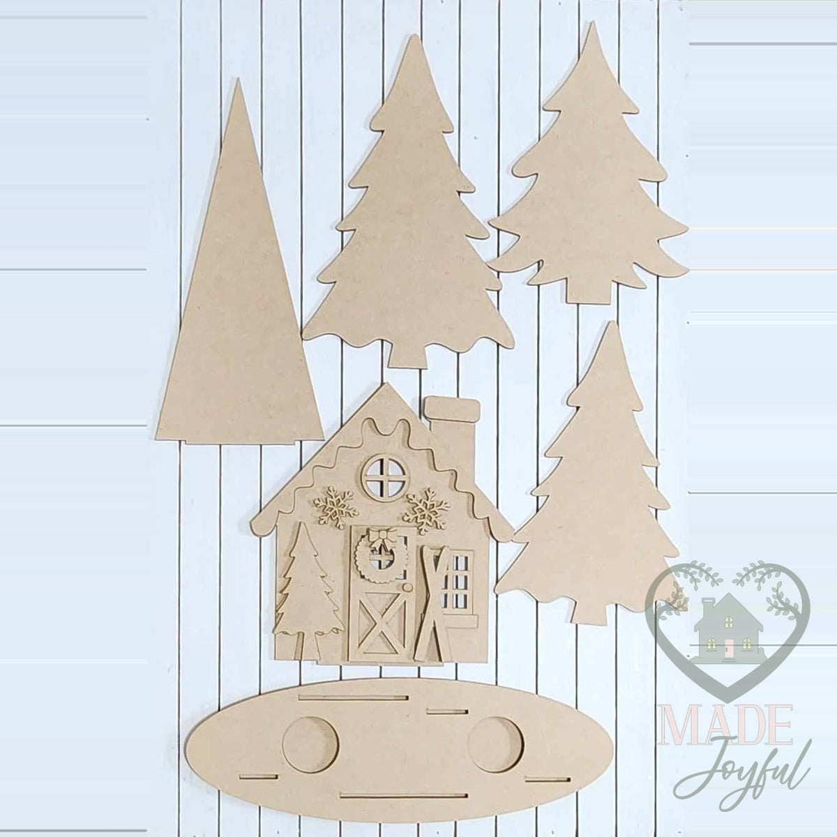 Unfinished laser-cut wood Winter Cabin Mantel Scene DIY kit, ready to paint at a DIY party in Williamson County, TN.