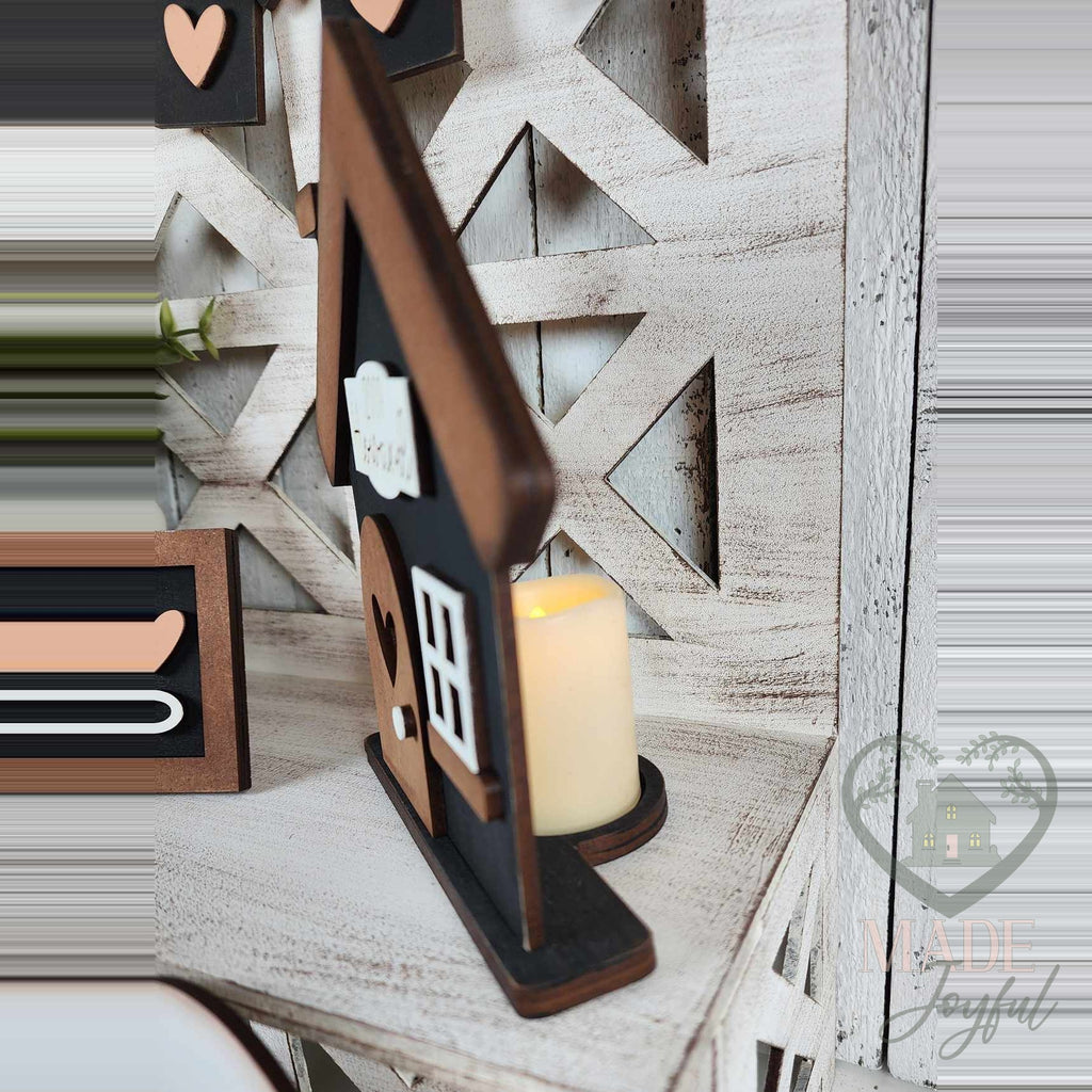 Family house votive holder glowing from a tealight, hand-painted in Brentwood, TN.