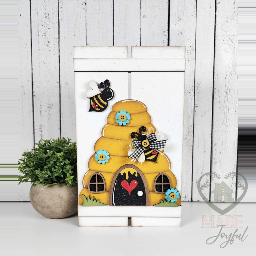 Beehive pallet leaner painted white with a yellow beehive and bees, hand-painted in Brentwood, TN.