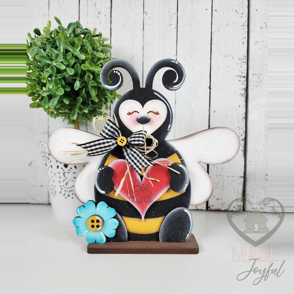 Bumblebee shelf sitter holding a red heart, hand-painted in Brentwood, TN.