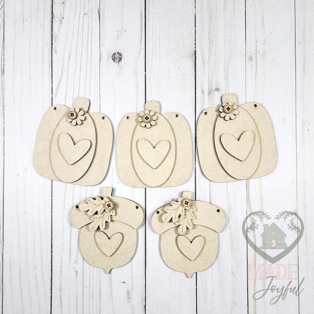 Unfinished laser-cut wood Fall Harvest Pumpkin & Acorn Banner DIY kit, ready to paint at a DIY party in Williamson County, TN.