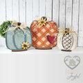 Trio of harvest pumpkin shelf sitters in teal, orange lattice, and white with sunflowers, hand-painted in Brentwood, TN.