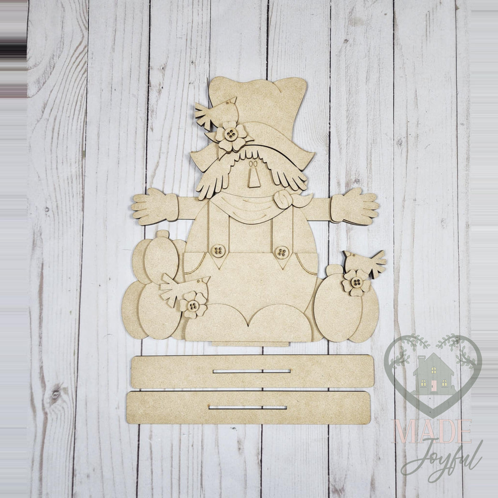 Unfinished laser-cut wood Fall Scarecrow Shelf Sitter DIY kit, ready to paint at a DIY party in Williamson County, TN.
