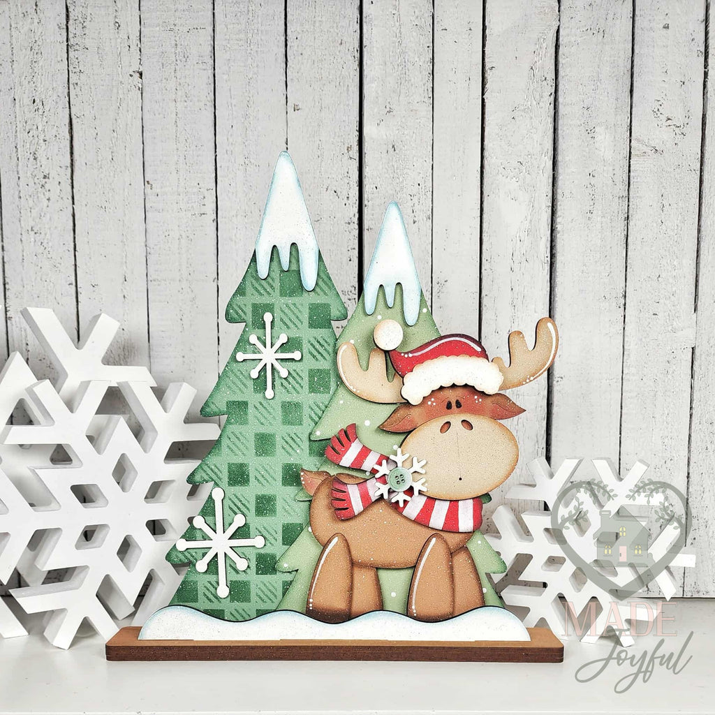 Christmoose standing moose shelf sitter with Santa hat and plaid trees, hand-painted in Brentwood, TN.