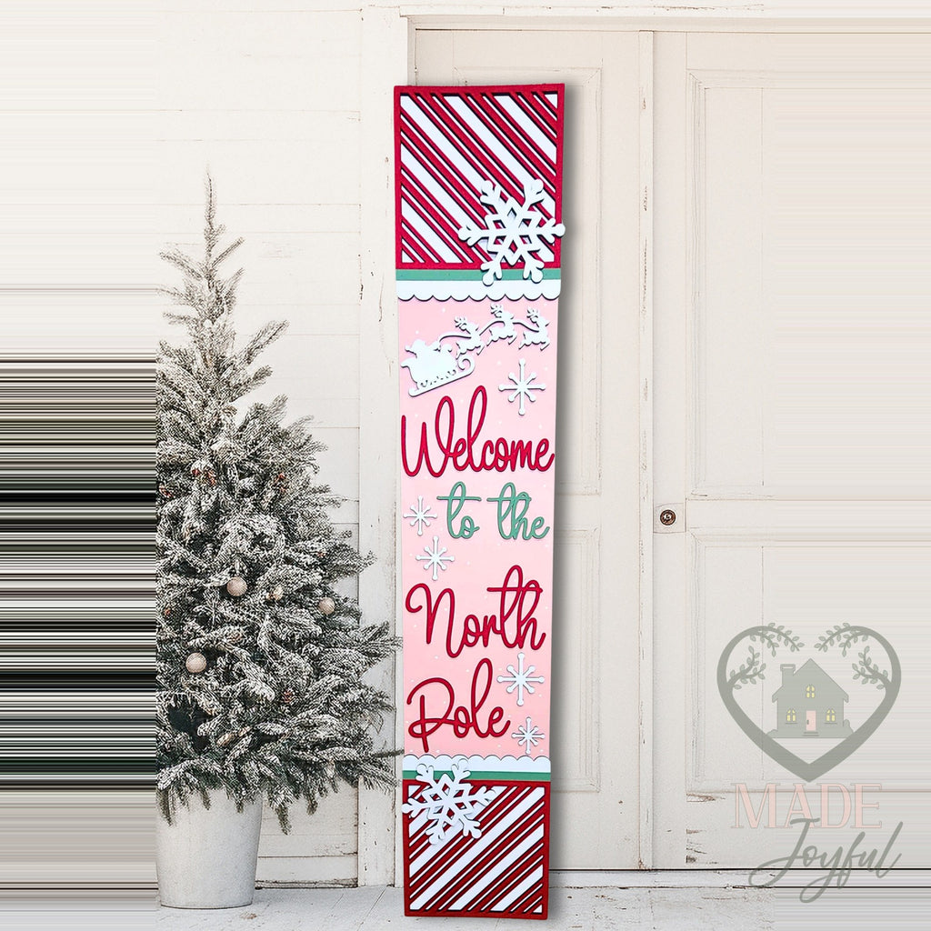 Welcome to the North Pole porch leaner with candy stripes on a front porch, hand-painted in Brentwood, TN.