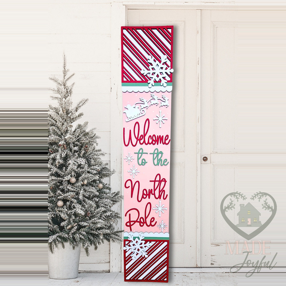 Welcome to the North Pole porch leaner with candy stripes on a front porch, hand-painted in Brentwood, TN.