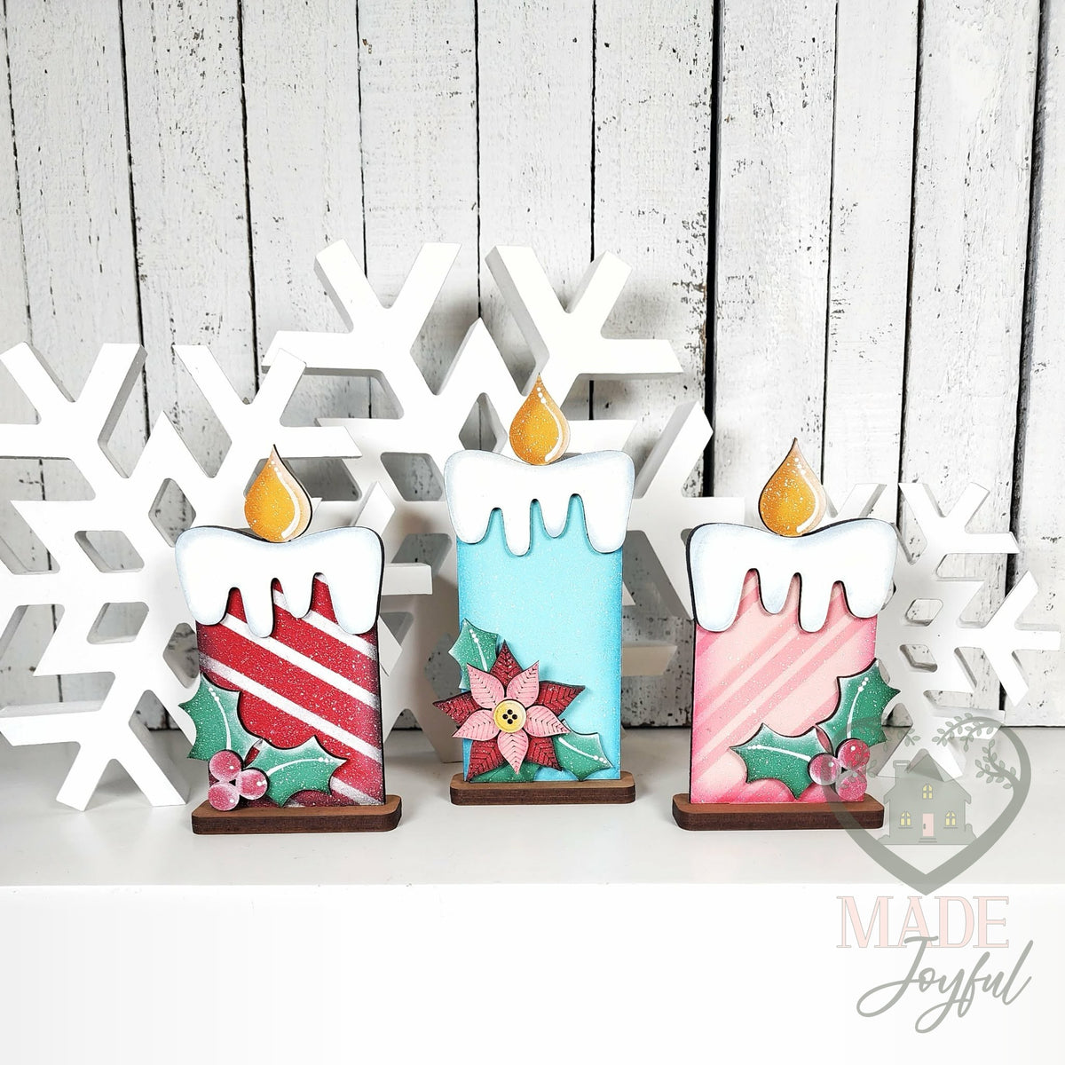 Trio of retro Christmas candle shelf sitters with stripes, poinsettia, and holly, hand-painted in Brentwood, TN.