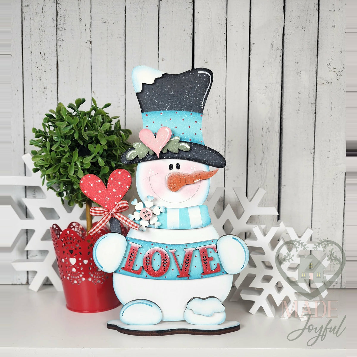 Love snowman shelf sitter in teal top hat holding LOVE sign, hand-painted in Brentwood, TN.