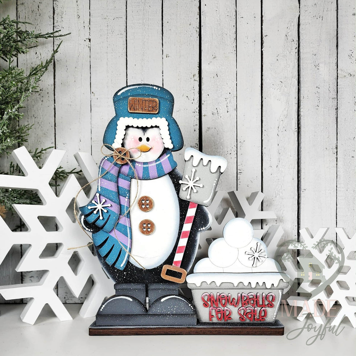 Penguin shelf sitter with trapper hat, shovel, and Snowballs for Sale bucket, hand-painted in Brentwood, TN.